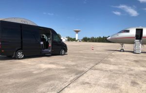 amiroad minibus next to a private jet in lisbon airport