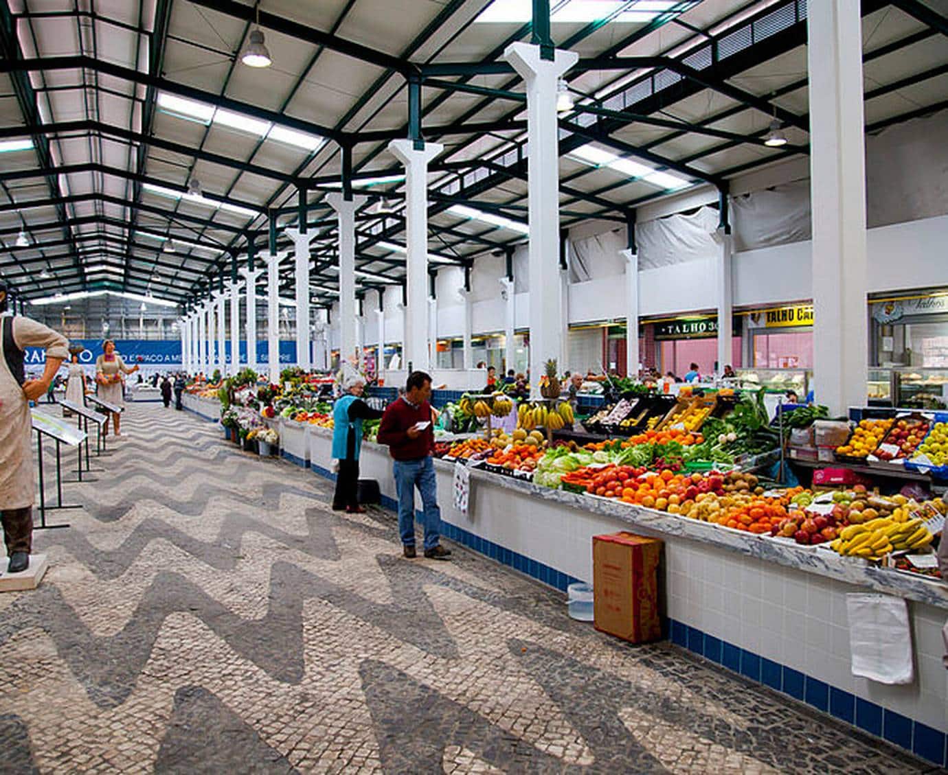 Colorful fruit and vegetable stalls inside the covered Mercado do Livramento in Setubal, Portugal