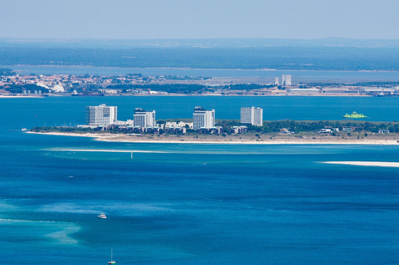 Aerial view of the Troia peninsula resort towers on a sandy spit with Setubal visible across the estuary, Portugal