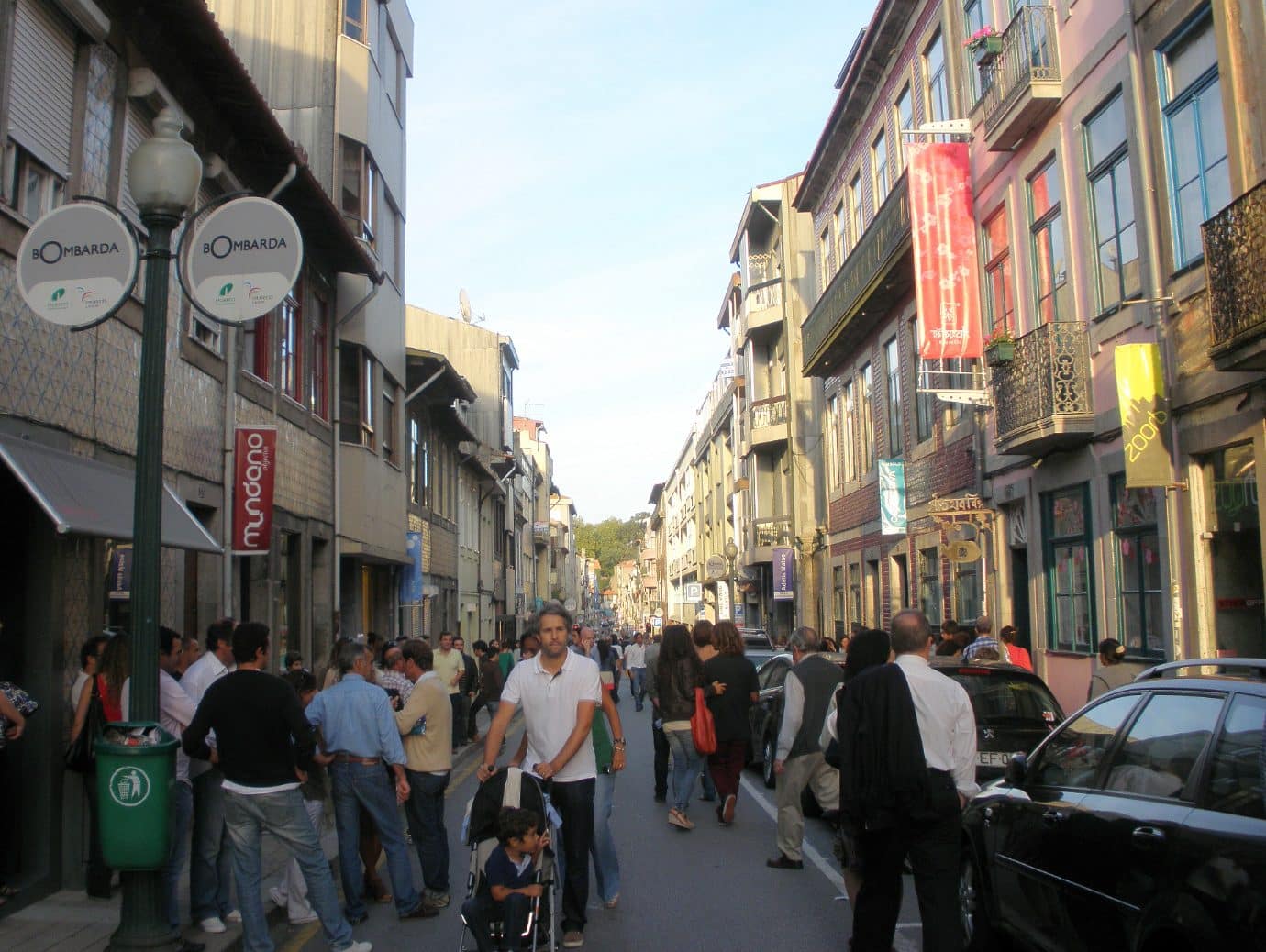 Rua Miguel Bombarda street in Porto during a gallery opening, with crowds and gallery banners along the street