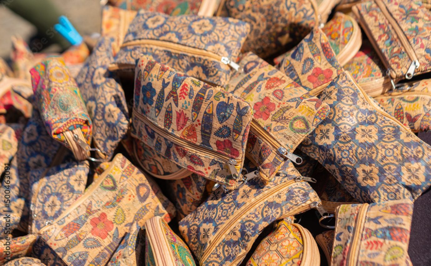 Pile of colorful patterned Portuguese cork zip pouches and small bags for sale