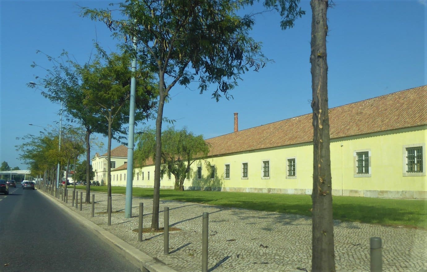 Long yellow facade of the Cordoaria Nacional in Belem, Lisbon, the 18th-century former naval rope factory that hosts the ARCOlisboa art fair
