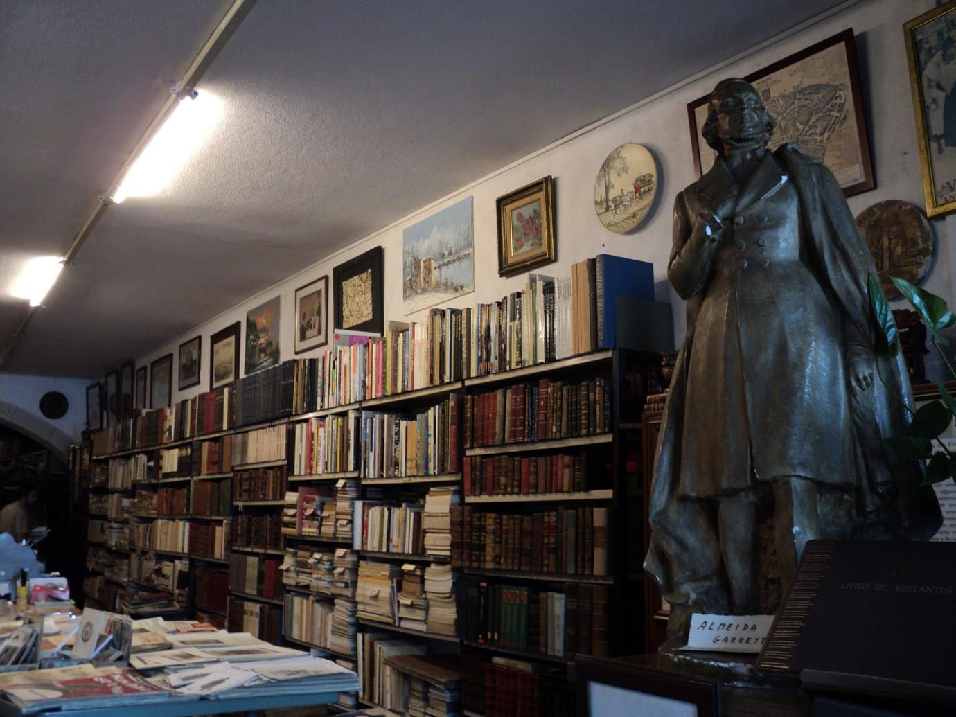 Interior of Livraria Chamine da Mota antiquarian bookshop in Porto, with densely packed shelves of used books