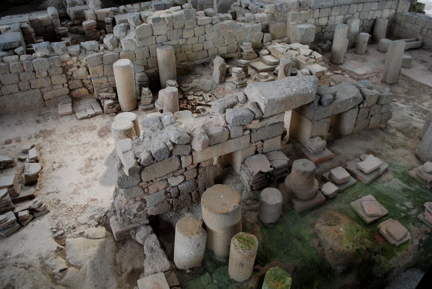 Excavated Roman ruins with stone hypocaust columns at the Bracara Augusta baths in Braga