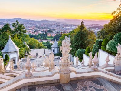 Sunset view over Braga from Bom Jesus do Monte Sunset view over Braga from the top of the Bom Jesus do Monte staircase with baroque statues in the foreground
