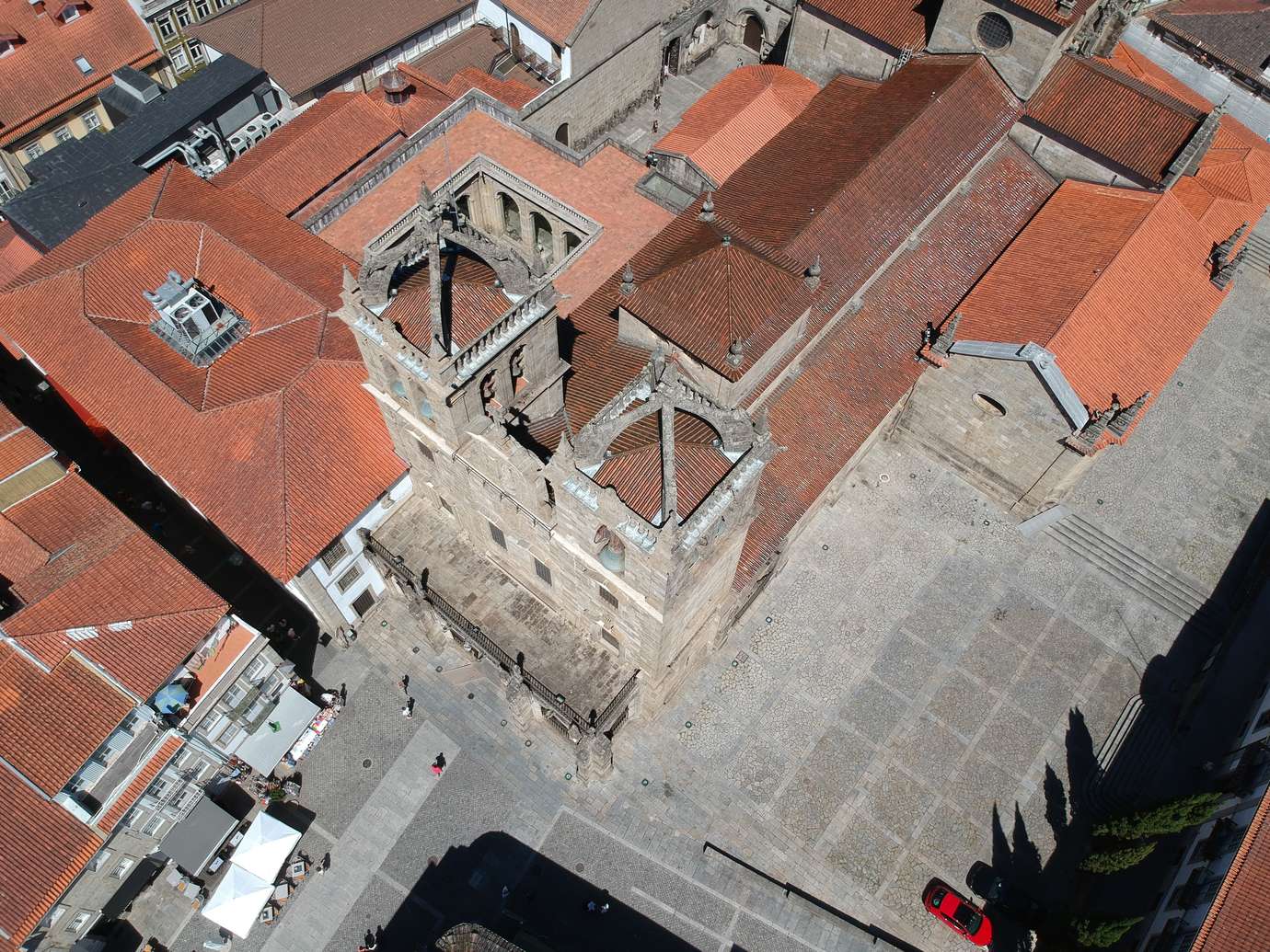 Aerial view directly above the bell tower and terracotta rooftops of Se de Braga cathedral