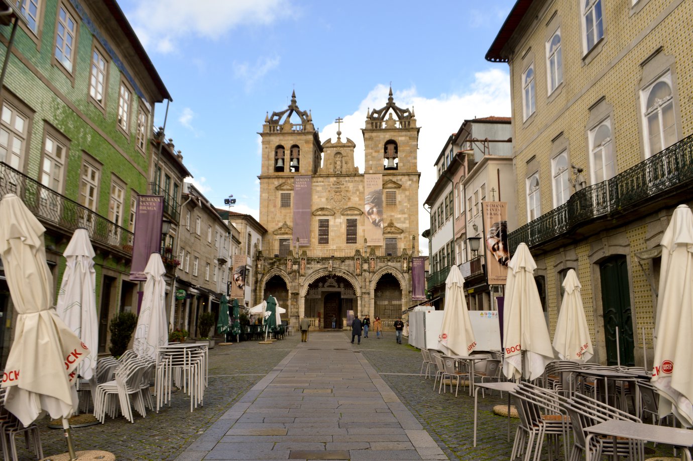 Main facade of Se de Braga cathedral with its twin bell towers seen from the pedestrian square in front