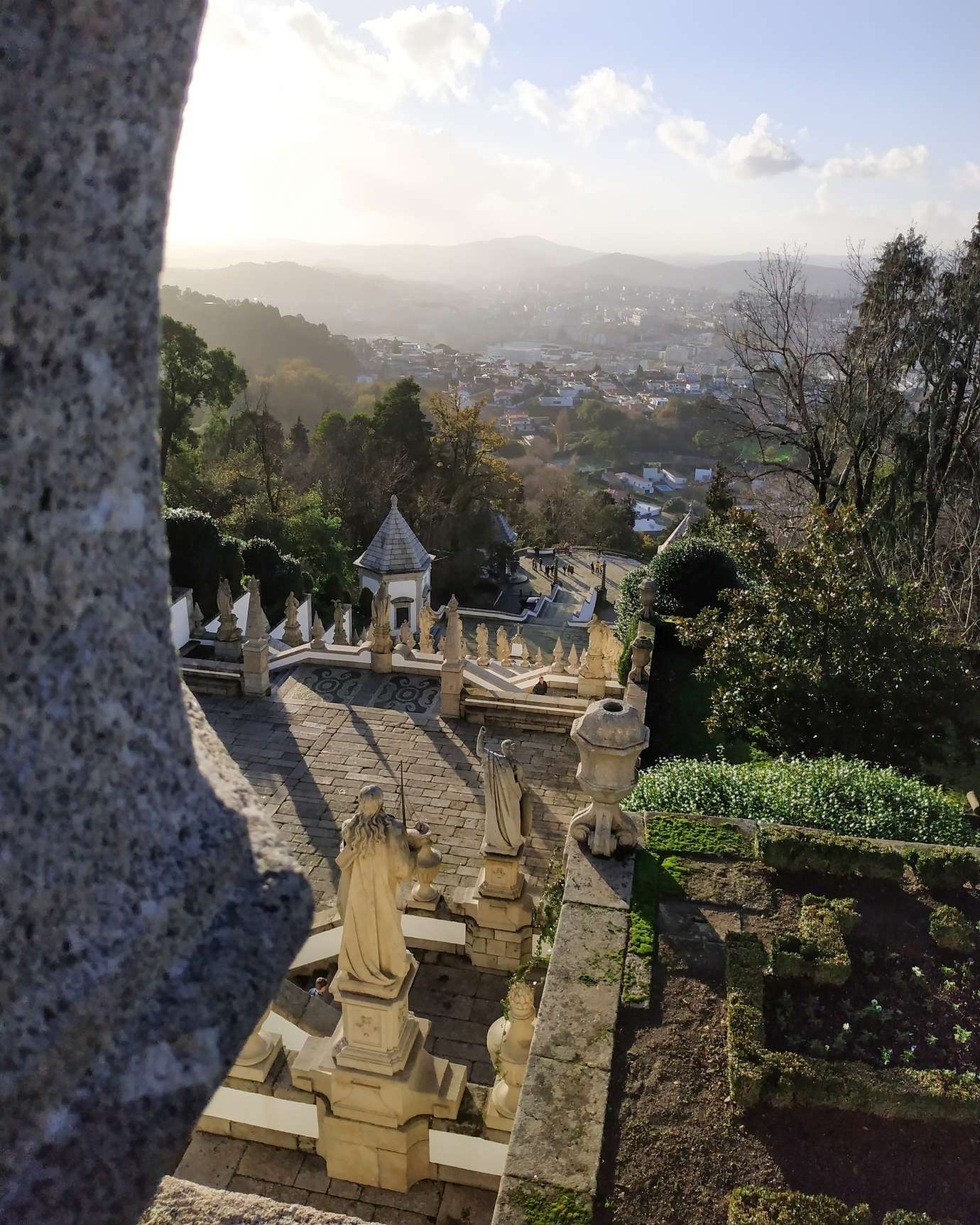 View down the baroque staircase at Bom Jesus do Monte with statues and the city of Braga visible below
