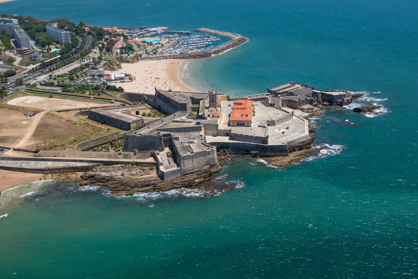 Aerial view of the Cidadela de Cascais fortress with the marina and beach along the Portuguese coastline