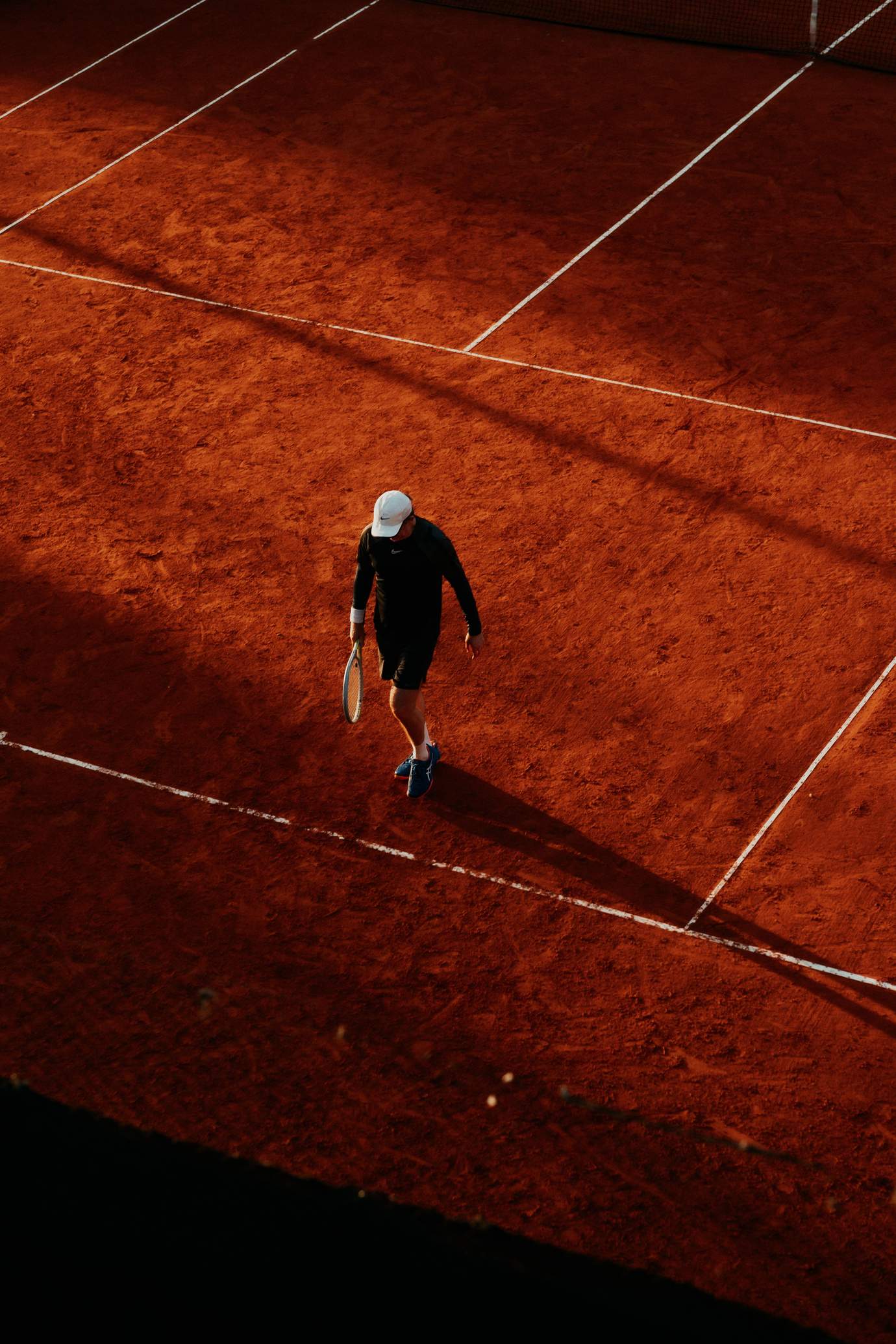 Aerial view of a clay tennis court, the surface used at the Millennium Estoril Open