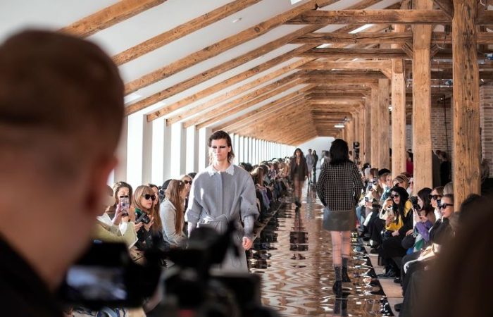 Models walking a runway at a fashion week show