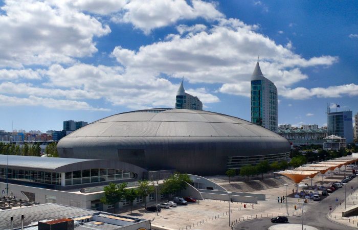 MEO Arena dome and Parque das Nacoes towers under a blue sky, Lisbon