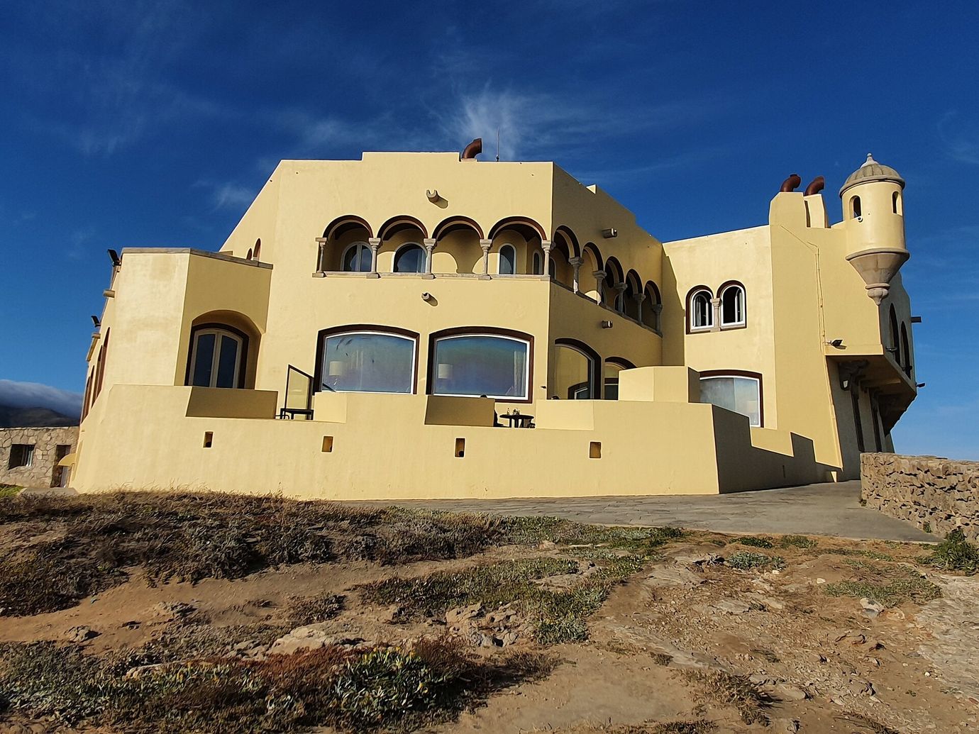 The yellow walls of Fortaleza do Guincho, a former fort turned hotel and one-Michelin-star restaurant on the coast near Cascais